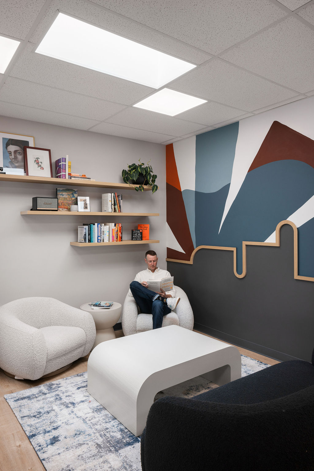 The Eclective reading lounge with curated art and bouclé chairs